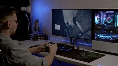 A young man is playing a console. gamer is playing on the gamepad. Stock Footage 127058164
