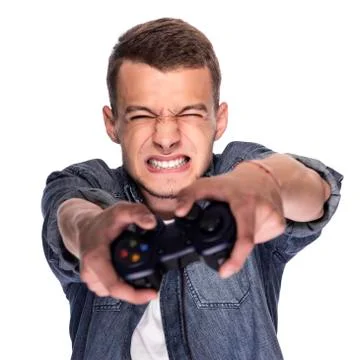 Young man playing on console or computer. Stock Photos