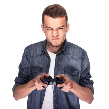 Young man playing on console or computer. Stock Photos