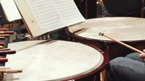 Young man playing drums in an orchestra Stock Footage 108371365