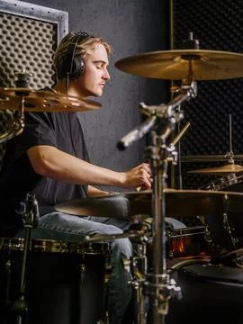 Young man playing drums in a recording studio Stock Photos