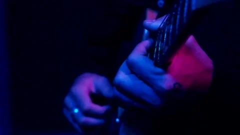 Young man playing electric guitar like a rockstar on blue background Stock Footage 139499731