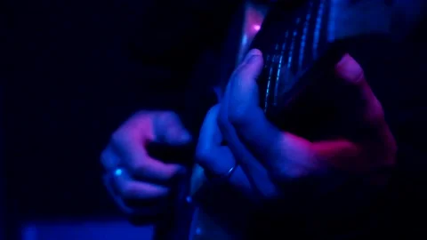 Young man playing electric guitar like a rockstar on blue background Stock Footage 139499740