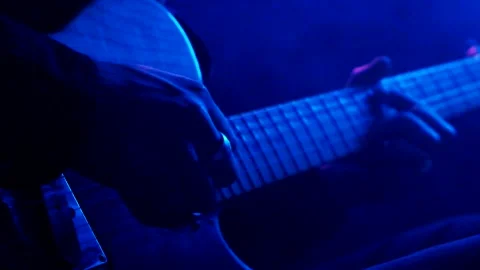 Young man playing electric guitar like a rockstar on blue background Stock Footage 139499754