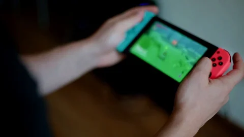 Young man playing game on Nintendo Switch Stock Footage 83455834