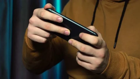 Young man playing game on smartphone Stock Footage 147752482