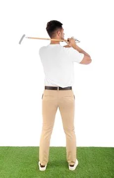 Young man playing golf on course against white background Photos