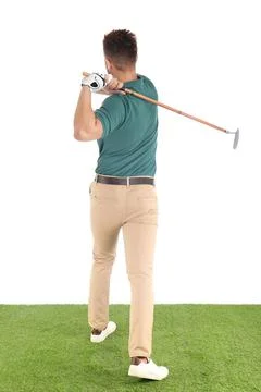 Young man playing golf on course against white background Photos