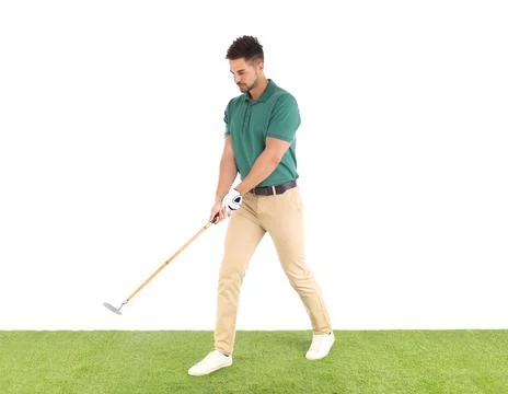Young man playing golf on course against white background Photos