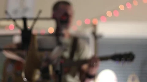 Young man playing guitar and singing Stock Footage 144885895