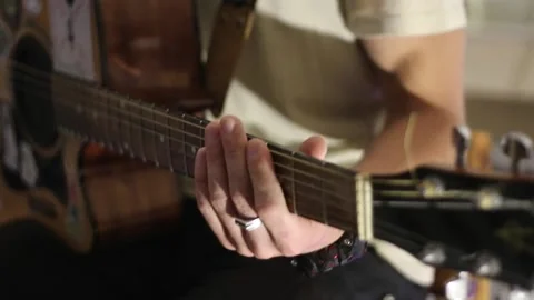 Young man playing guitar and singing Stock Footage 144886301