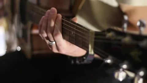 Young man playing guitar and singing Stock Footage 144886360