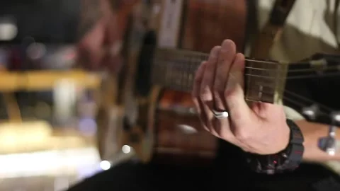 Young man playing guitar and singing Video stock 144886433
