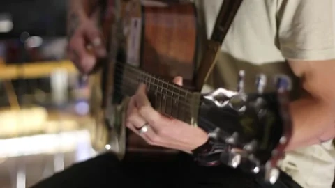 Young man playing guitar and singing Stock Footage 144886920