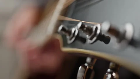 Young man is playing a guitar. close up of string and fingers Stock Footage 301308863