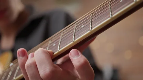 Young man is playing a guitar. close up of string and fingers Stock Footage 301309378