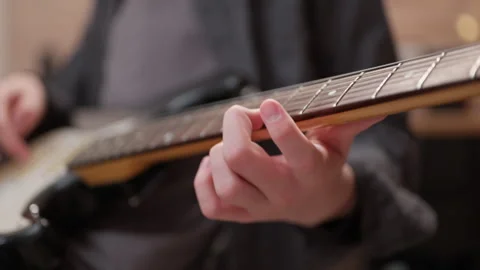 A young man is playing a guitar. close up of string and fingers. close up of Vídeo Stock 301310321