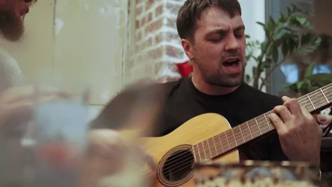 Young man playing guitar Stock Footage 73629139