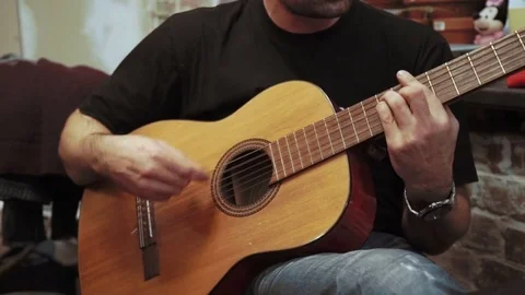 Young man playing guitar Stock Footage 73629627