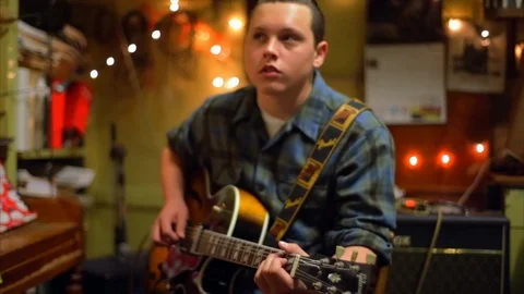 Young man playing guitar. Stock Footage 88407191
