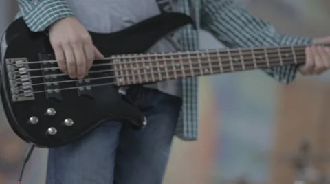 Young man playing the guitar hands closeup Stock Footage 57693086
