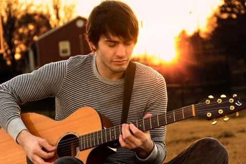 Young man playing guitar Stock Photos