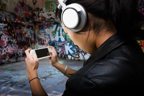 A young man playing on a handheld computer Stock Photos