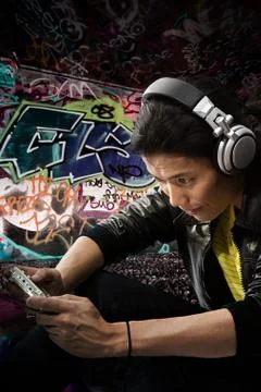 A young man playing on a handheld computer Stock Photos