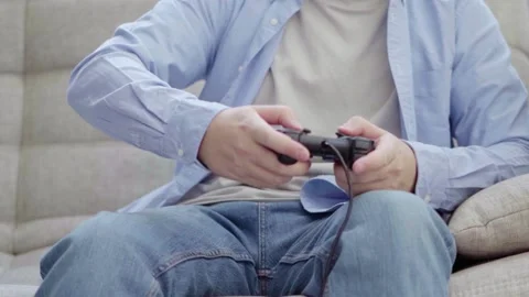 Young man playing on a joystick Stock Footage 160559078