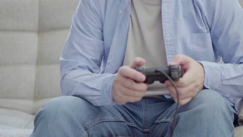Young man playing on a joystick Stock Footage 164543606
