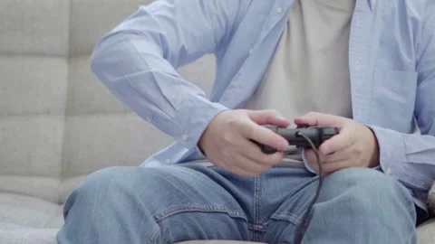 Young man playing on a joystick Video stock 166155914
