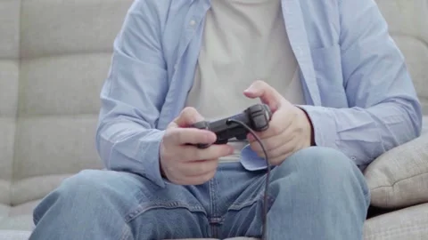 Young man playing on a joystick Stock Footage 166912254