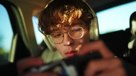 Young man playing mobile game in car Stock-Footage 312404133