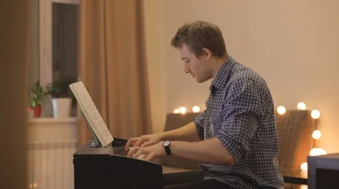 Young man playing the piano Stock Footage 59979425