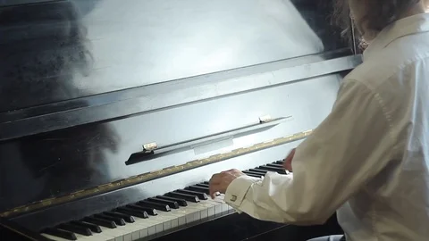 Young man playing the piano. Stock Footage 89776970