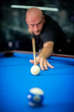Young man playing pool game in pub Stock Photos