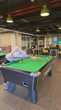 Young Man Playing Pool in a Modern Recreation Room Stock Photos