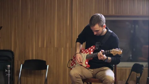 Young Man Playing Red and White Electric Guitar Stock Footage 72193663