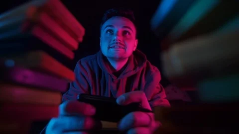 Young man playing retro console,dark room,retro lighting Stock Footage 126094574