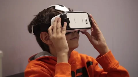 Young man playing with Samsung virtual reality glasses. Virtual reality game Stock Footage 65482200