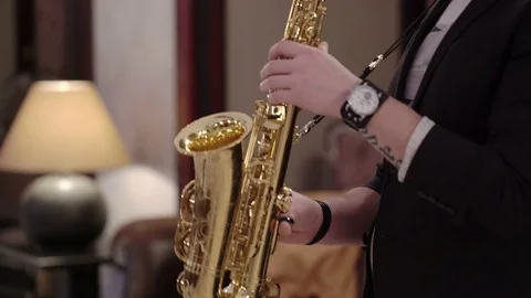 Young man playing saxophone Stock Footage 73702107