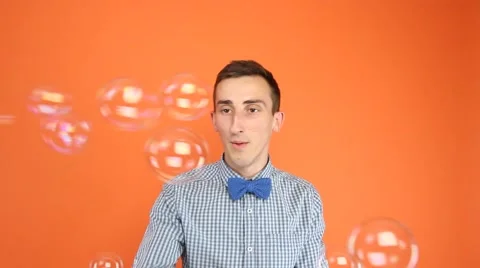Young Man Playing with Soap Bubbles Stock Footage 51221198