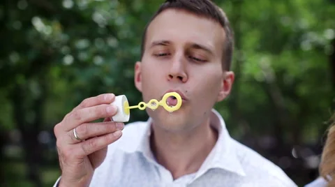 Young man playing with soap bubbles Stock Footage 64067250