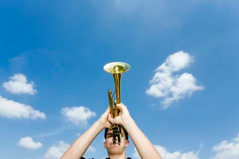 Young man playing trumpet, low angle view Stock Photos
