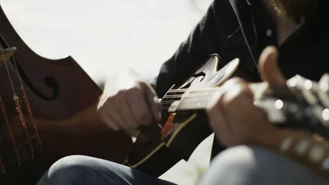 Young Man Playing Ukulele With a Guitar Pick Stock Footage 90131580