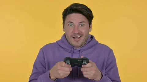 Young Man Playing Video Game, Yellow Background 스톡 동영상 141673354