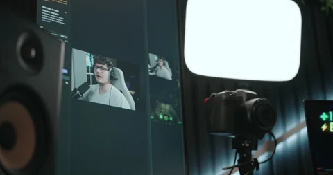 Young man playing video games and setting up a livestream Stock Footage 306199696