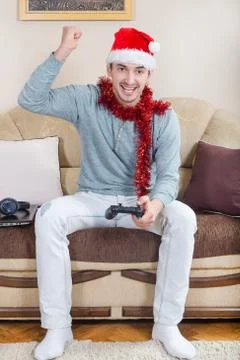 Young man playing video games with wireless Bluetooth joystick Stock Photos