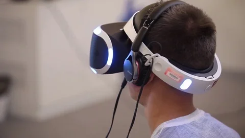 Young man playing with virtual reality glasses. Virtual reality game Stock Footage 72288244