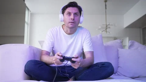 Young man plays catch game with controller non-stop and lost Stock Footage 171595009